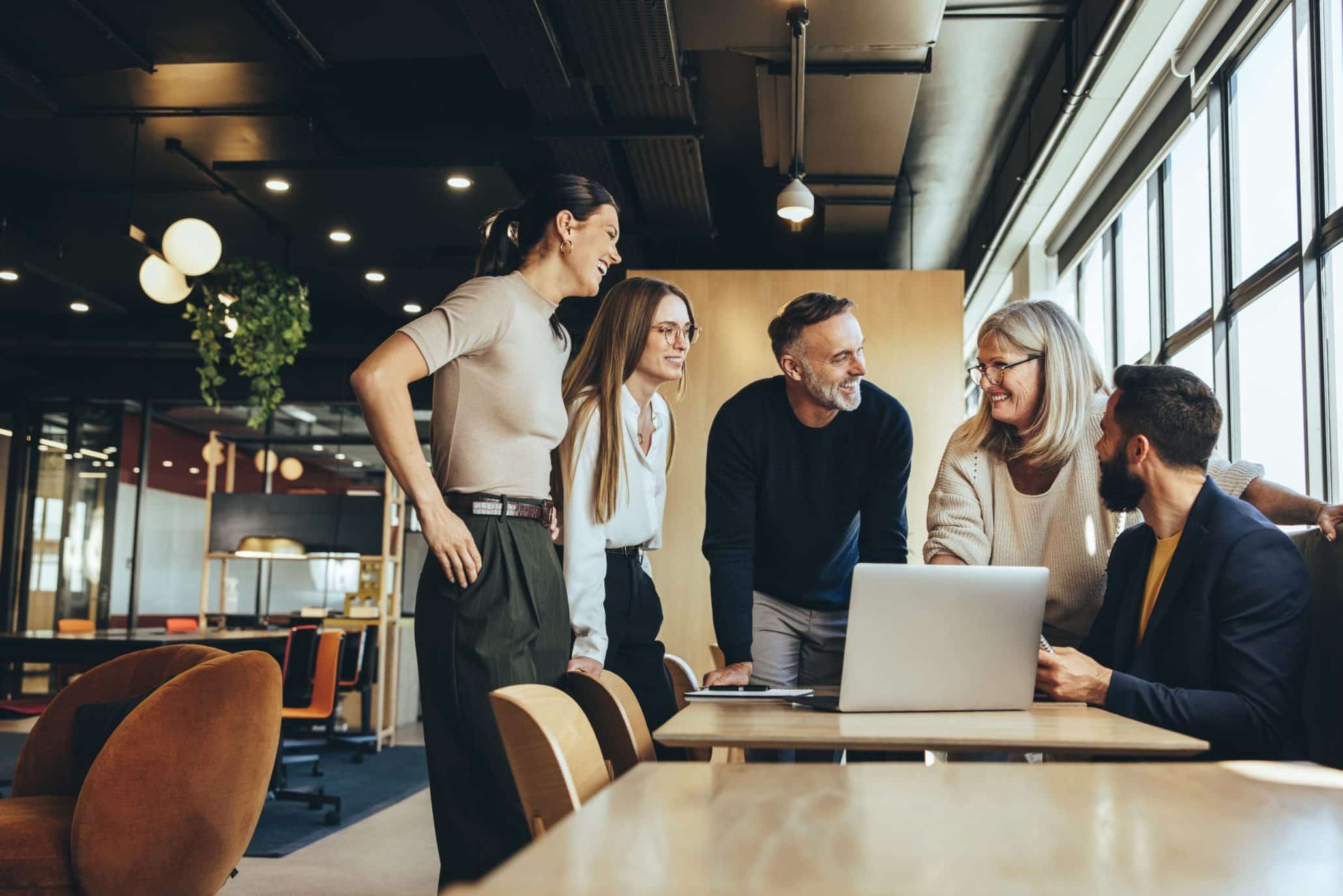 Smiling,Businesspeople,Having,A,Discussion,While,Collaborating,On,A,New Dedicated Support